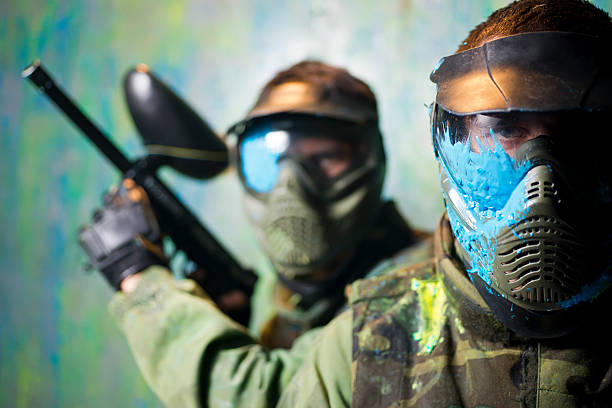 Gros plan sur deux hommes masqués lors d'une partie de paintball